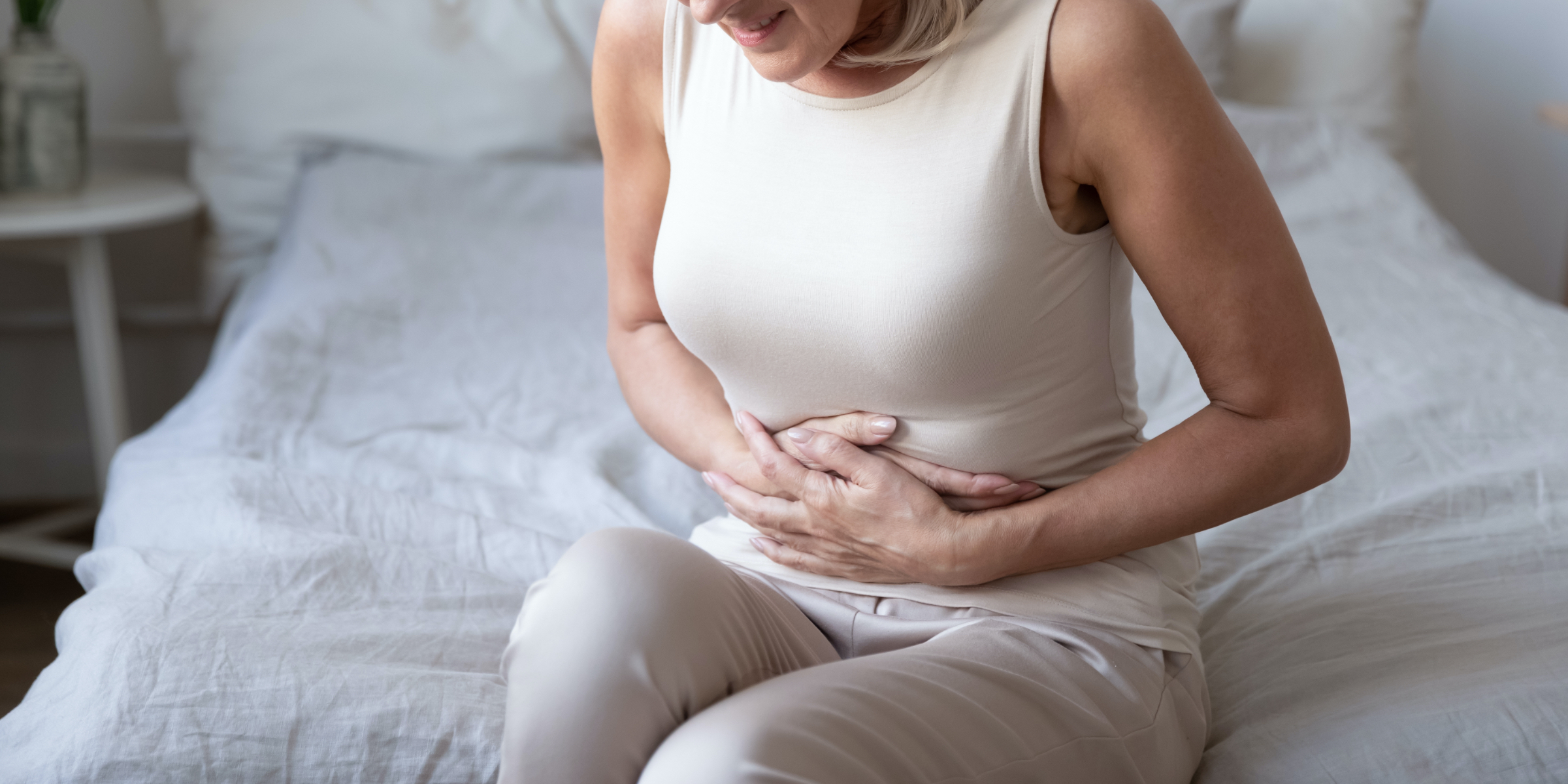 Woman with a digestive disorder clutching her stomach