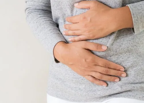 Man clutching his stomach in pain