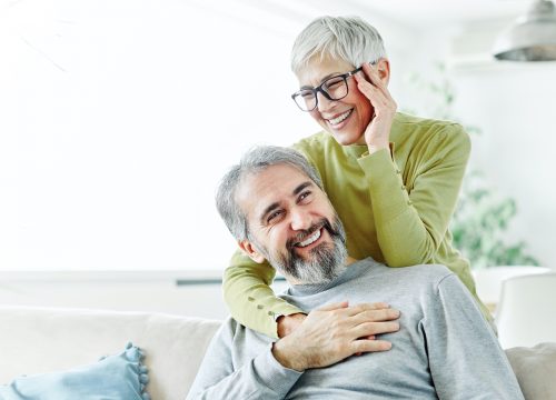 Older couple laughing in their living room