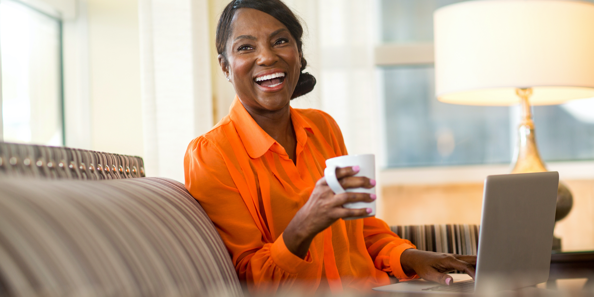 Happy woman having a cup of coffee at home