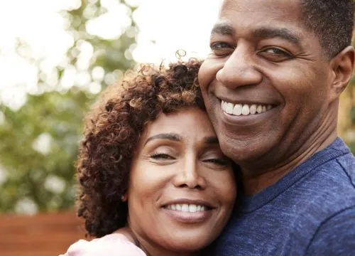 Husband and wife hugging and smiling