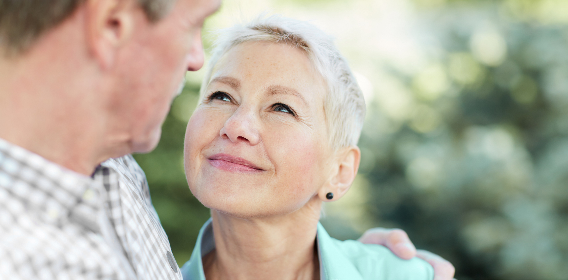 Older woman with great skin looking at her husband