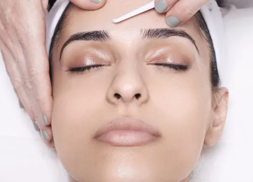 Woman receiving dermaplaning treatments