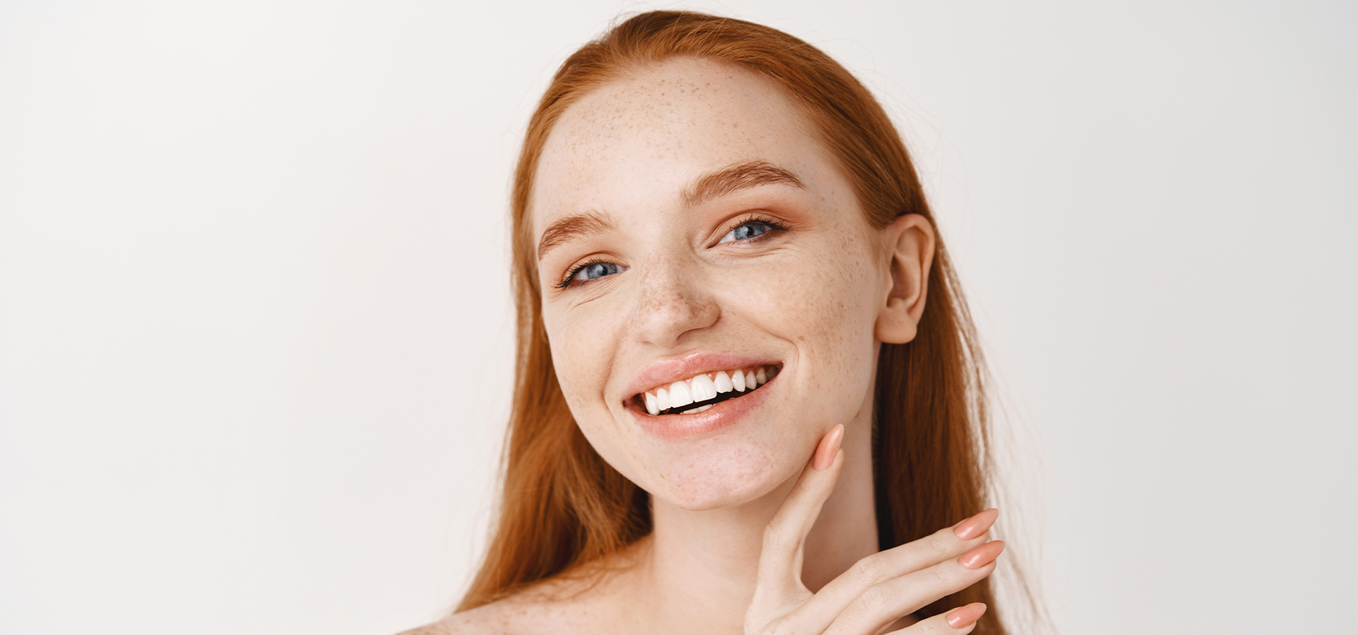 Photo of a red-headed woman with great skin