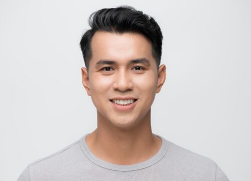 Photo of a smiling man wearing a gray t-shirt
