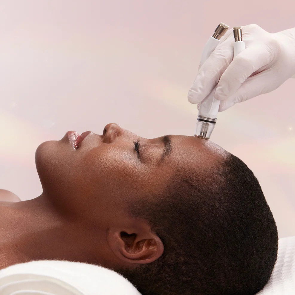 Photo of the Diamond Glow device being used on a woman's forehead